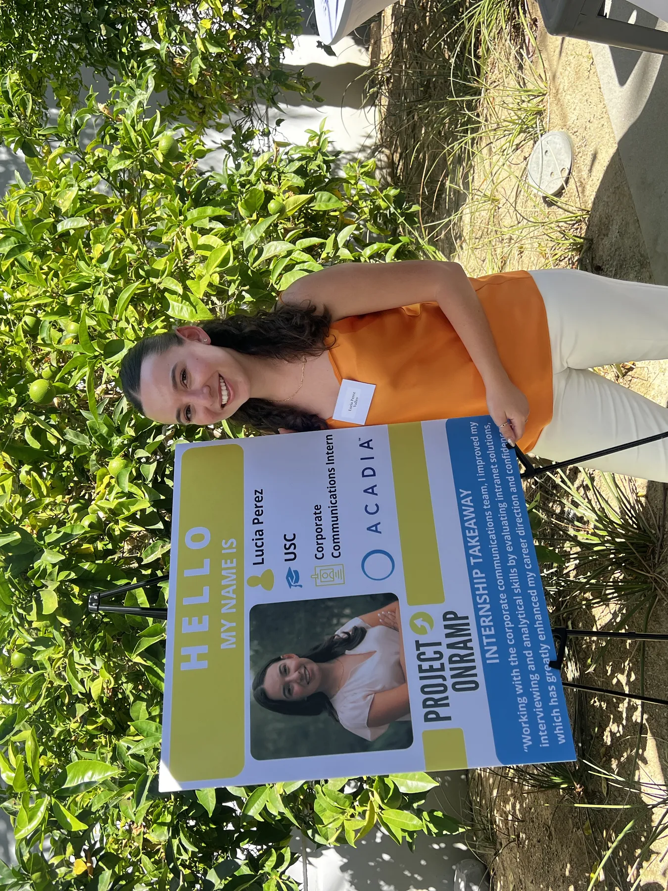 Intern named Lucia Perez presenting her internship project poster, detailing her role and experience with Acadia’s Corporate Communications team