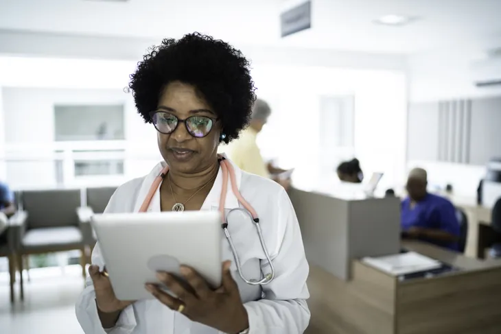 A doctor reading off an iPad